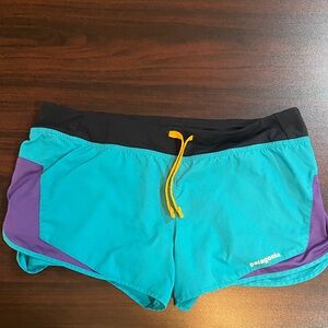 Patagonia Teal Running Shorts with Purple Panels and Yellow Drawcord